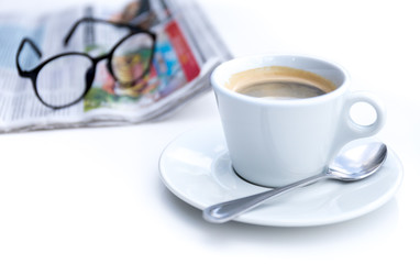 Cup of coffee in morning with newspaper and glasses