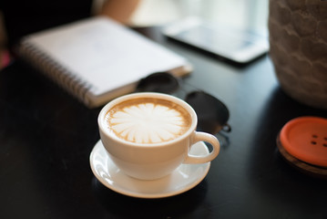Coffee cup on wooden table on back background