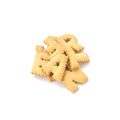 Closeup pile of brown biscuit in english alphabet isolated on white background