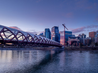 Calgary's skyline along the Bow River at sunrise. 