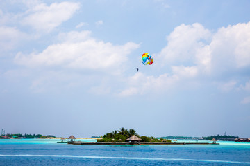 Parasailing over Tropical Island Crystal Clear Blue Ocean Water