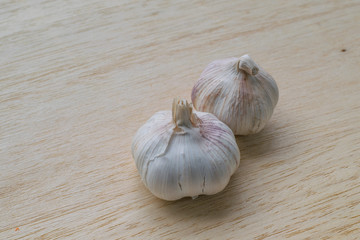 two garlic  on wood desk
