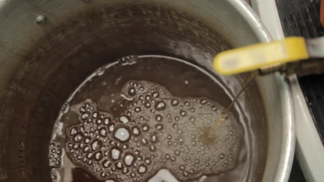 Beer Flowing From Orange Cooler Valve Into Boil Pot - Home Craft Beer Brewing