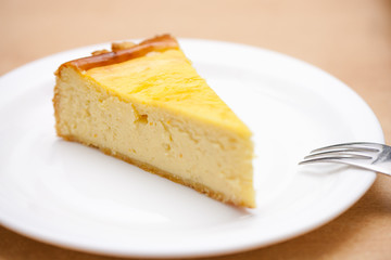 a piece of cheese cake on a white plate