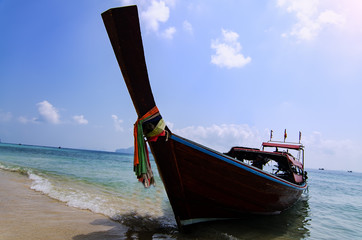 Longtail boat anchored at Ao Loh Dalum beach on Phi Phi Don Island, Krabi Province, Thailand. Koh Phi Phi Don is part of a marine national park.