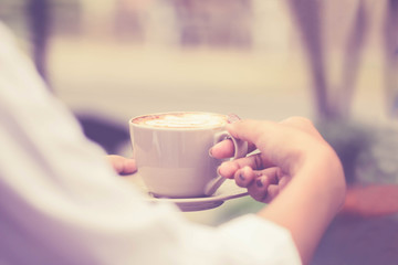 Closer up the coffee mug in hand women business during the time relax Vintage tone