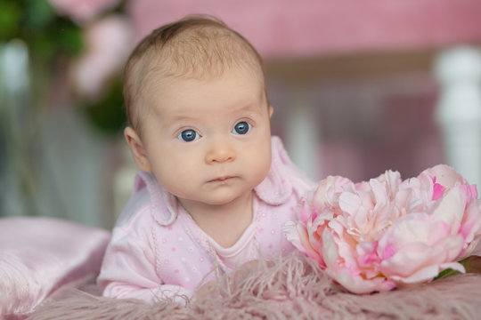 Portrait of adorable baby girl in pink dress
