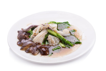 Stir fried kale with fresh squid on white dish