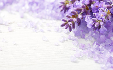 Few sprigs of lavender and  mineral bath salts on  the wooden table.  Shallow DOF. Selective focus