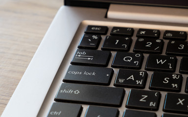 Obraz premium Laptop keyboard on wood background