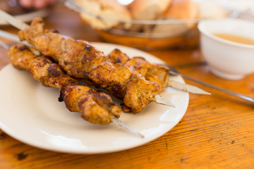 Fried shish kebab on sticks in a cafe