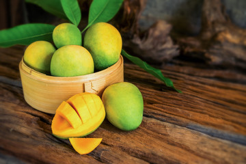 mango and mango slices on a wooden table