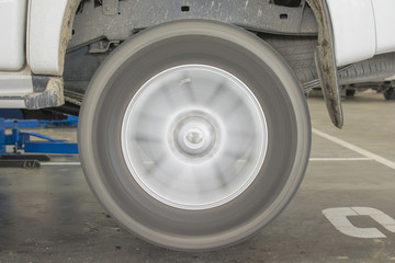 Checking the wheel of mini truck in the garage