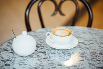 Cup of coffee on table in cafe.