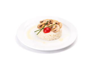 White rice dish with mushrooms and a tomato, on a plate isolated on a white background. Decorated by lettuce.