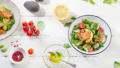 Fresh Salmon salad on a white wooden table. Healthy diet eating.