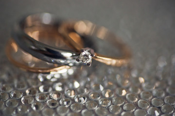 Close-up of wedding rings lying on sparkling cover