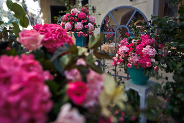 Large bouquets of hydrangeas stand before the mirror outside