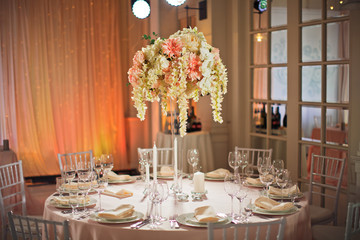 White branches hang from bouquet of delicate pink flowers