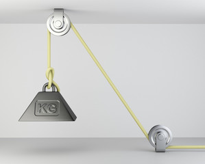 Weight with mass symbol tied on a roppe and block system.