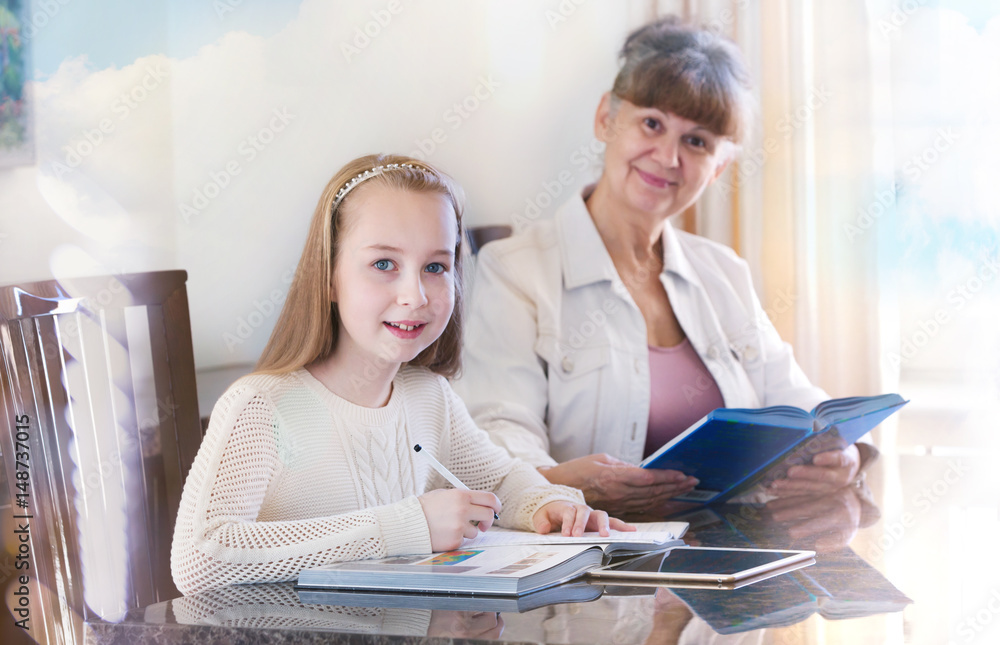 Wall mural 10 years old girl and her teacher. little girl study during her private lesson. tutorial and educati