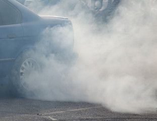 Smoke from under the wheels of the car