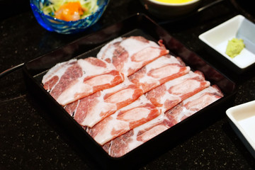 Shabu Shabu or Sukiyaki is a Japanese style and Korean style - Raw pork sliced for hot pot, Selective focus.