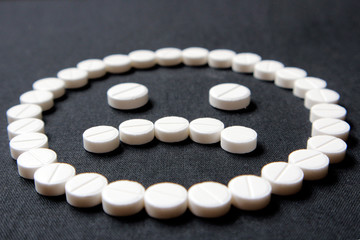 A sad smiley of pills. Concept - bad drugs, disease, expensive medicine.