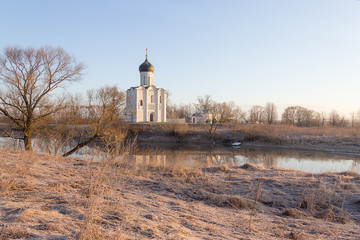 View to the Church of the Intercession of the Holy Virgin on the Nerl River in sunlight.