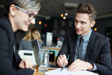 Young agent consulting his client in cafe