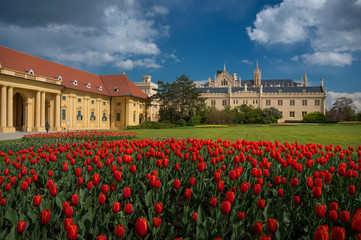 Beautiful view of Lednice Castle with storm clouds and blooming red tulips.Lednice palace is one of the most impressive and  visited historical sights in the Czech Republic. South Moravia attractions
