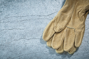 Fototapeta na wymiar Leather safety gloves on metallic background construction concep