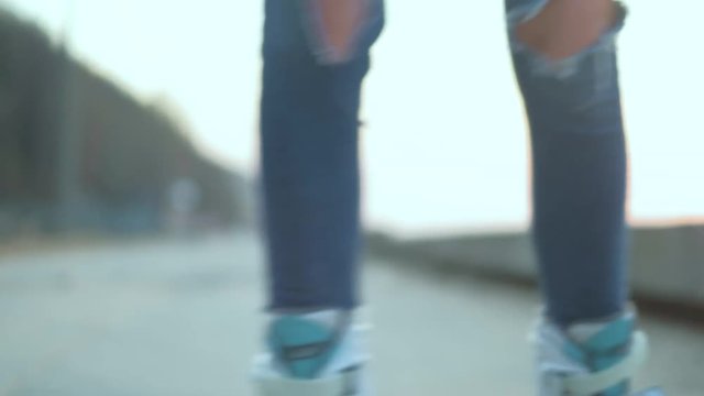 Beautiful woman roller-blading on the seashore 4k