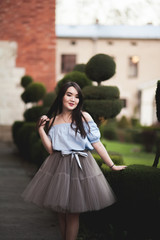 Fototapeta premium Young Asians girl with modern dress posing in an old Krakow