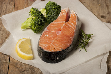 salmon raw. salmon red fish steak with herbs and lemon isolated on a white background