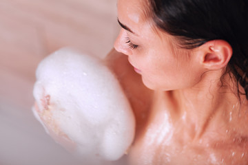 Young beautyful woman under shower in bathroom
