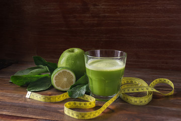 Green fresh pressed juice, detox, Apple, lime and spinach, in a transparent glass