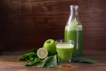 Green fresh pressed juice, detox, Apple, lime and spinach, in a glass container