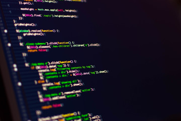 Software development. Software source code. Programming code. Writing programming code on laptop.