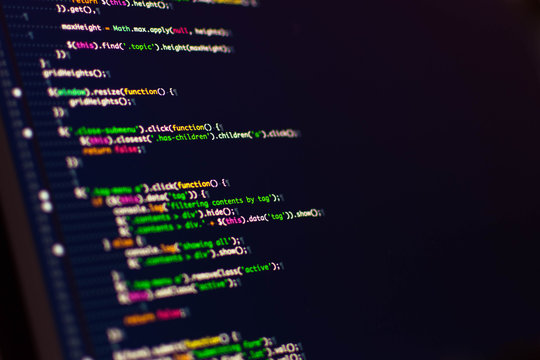 Software development. Software source code. Programming code. Writing programming code on laptop.