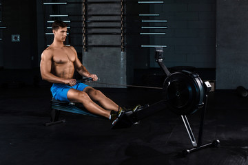 Fototapeta na wymiar Muscular man doing exercise for legs in the gym