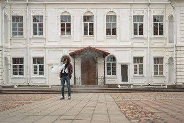 Vape man. Portrait of a handsome young white guy in the hood with modern haircut vaping and letting...