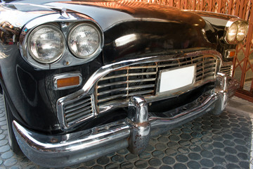 Obraz na płótnie Canvas Headlight lamp black vintage classic car with vintage effect style pictures. Side view of black classic car concept.