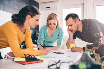 Group of people checking blueprints