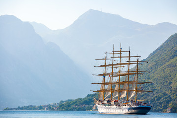 Beautiful sunny day in Montenegro. Big sailing ship is entering the Kotor bay (Boka Kotorska), Montenegro, Europe.