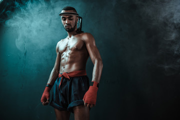 Fototapeta na wymiar Muay Thai athlete training at Thai boxing indoors, ultimate fight concept