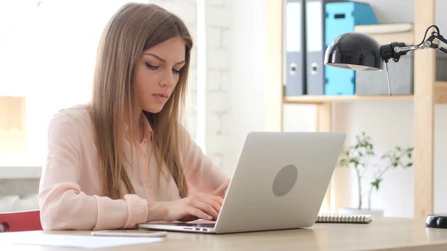 Creative Woman Working On Laptop in Office