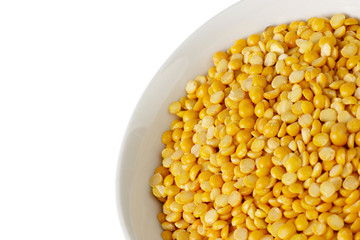 Dry yellow split peas isolated on white.