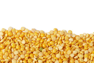 Dry yellow split peas isolated on white.