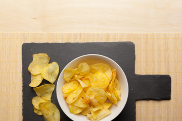 Potato chips in bowl on a table